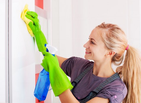 Cleaner working in a Richmond family home living room