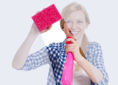Cleaner carrying out safe cleaning duties with protective gear